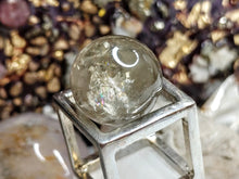 Load image into Gallery viewer, Rainbow Smokey Quartz Sphere with Selenite Stand
