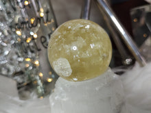 Load image into Gallery viewer, Flat Bottom Rainbow Honey Calcite Sphere on Selenite Stand
