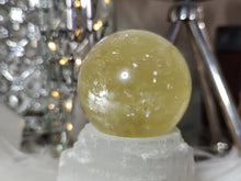 Load image into Gallery viewer, Flat Bottom Rainbow Honey Calcite Sphere on Selenite Stand
